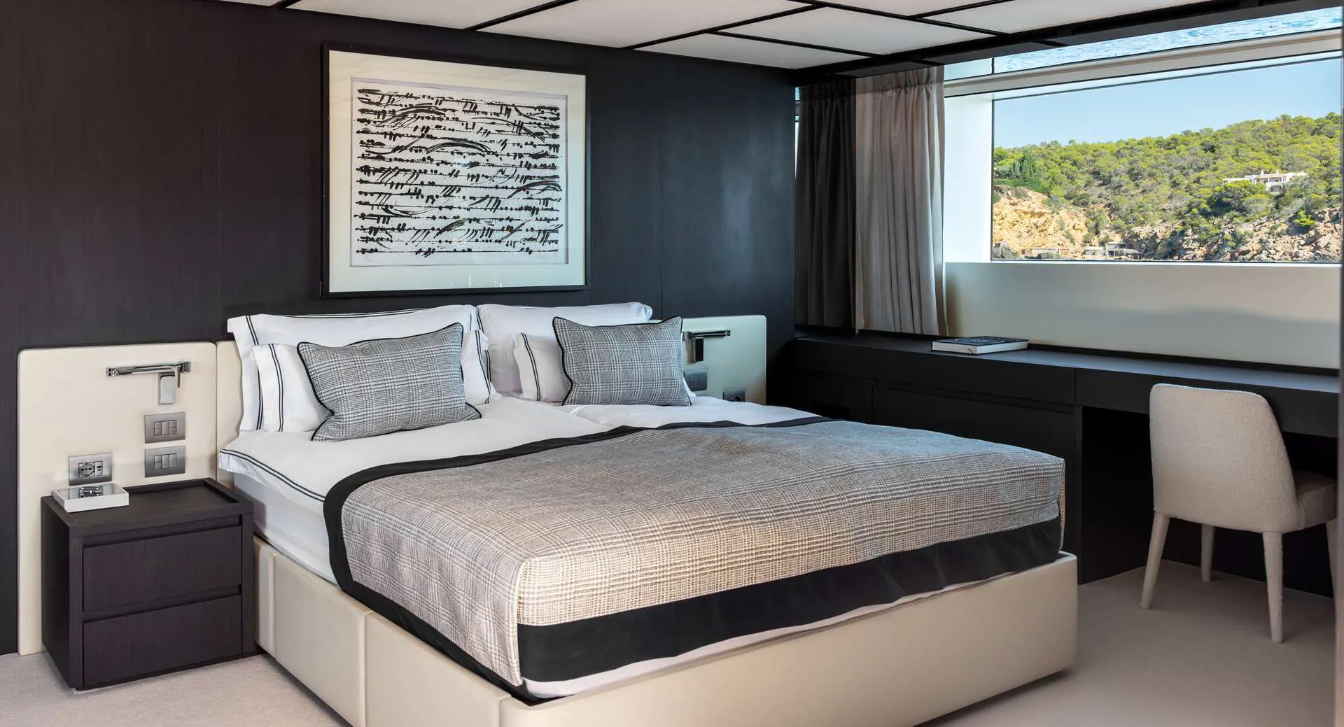 Master suite with a double bed, desk and wide window