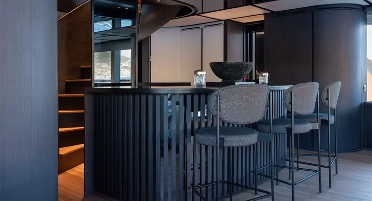 Bar with high stools beside the stairs