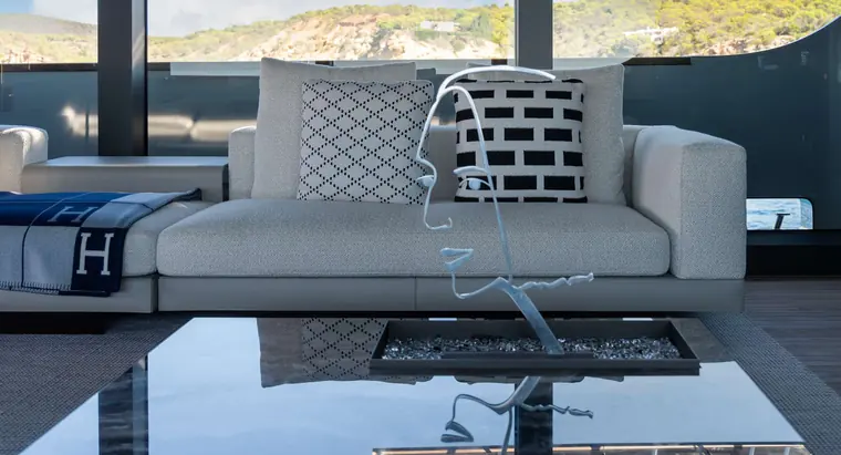Sofa with patterned cushions and a wire sculpture on the table