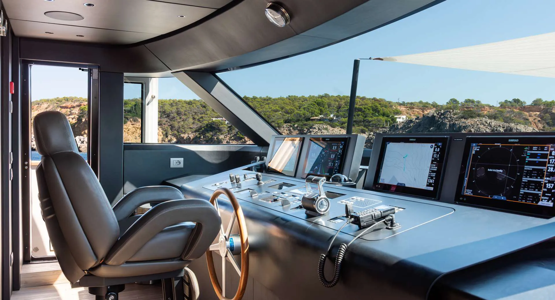 Wheelhouse with helm seat and navigation screens